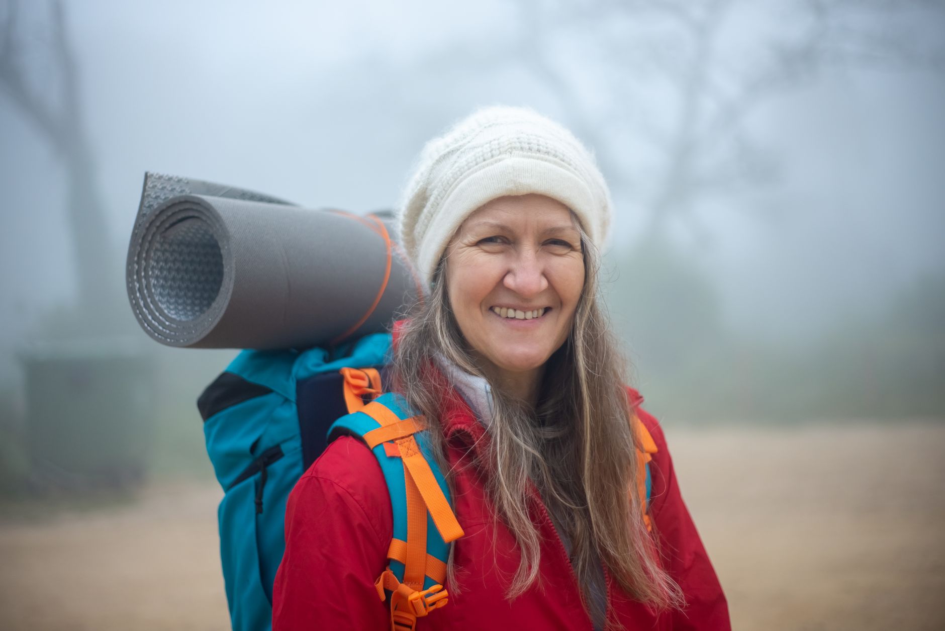 An active woman in her fifties smiling outdoors