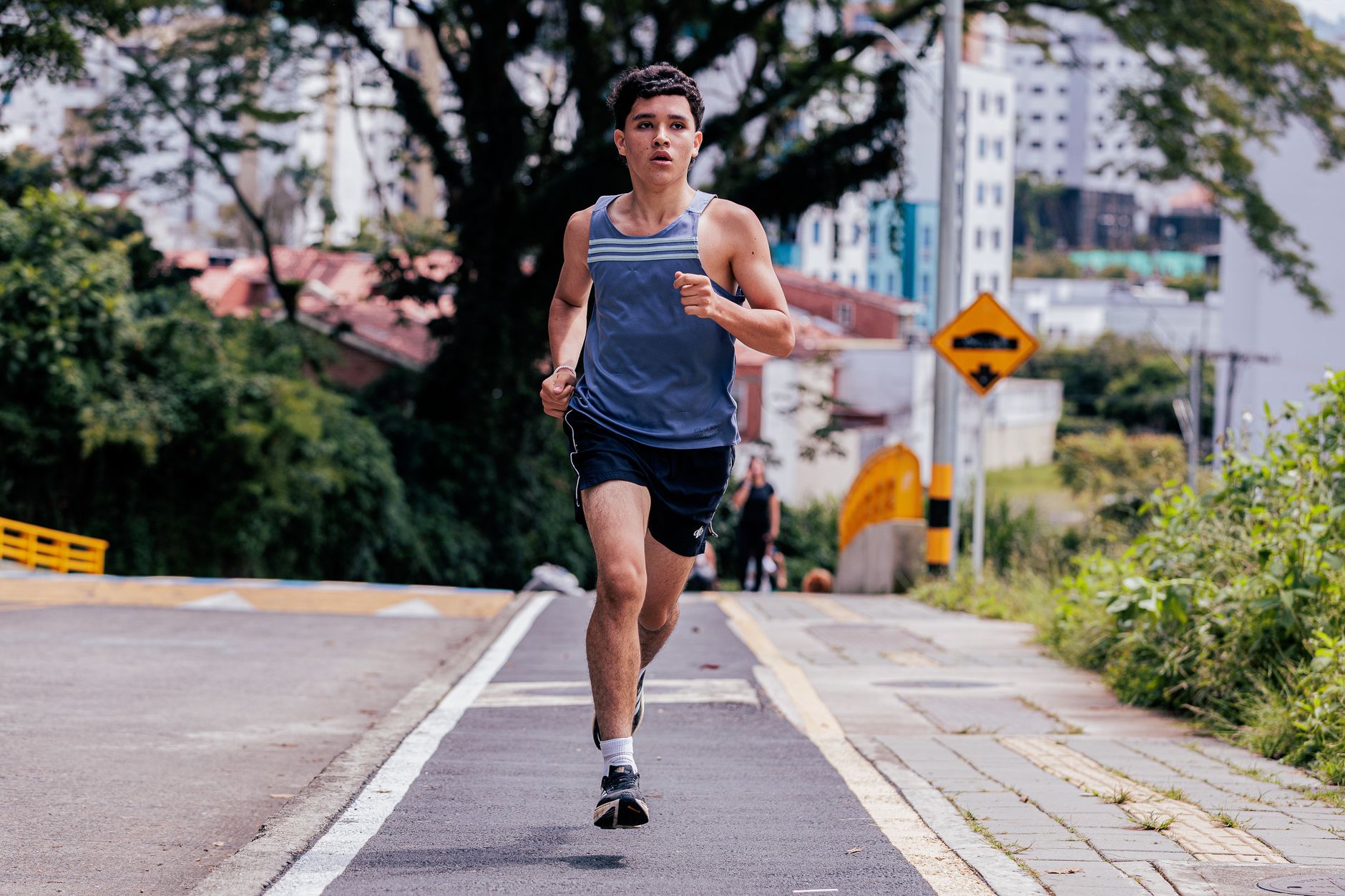 A young man running through the city, glasses-free