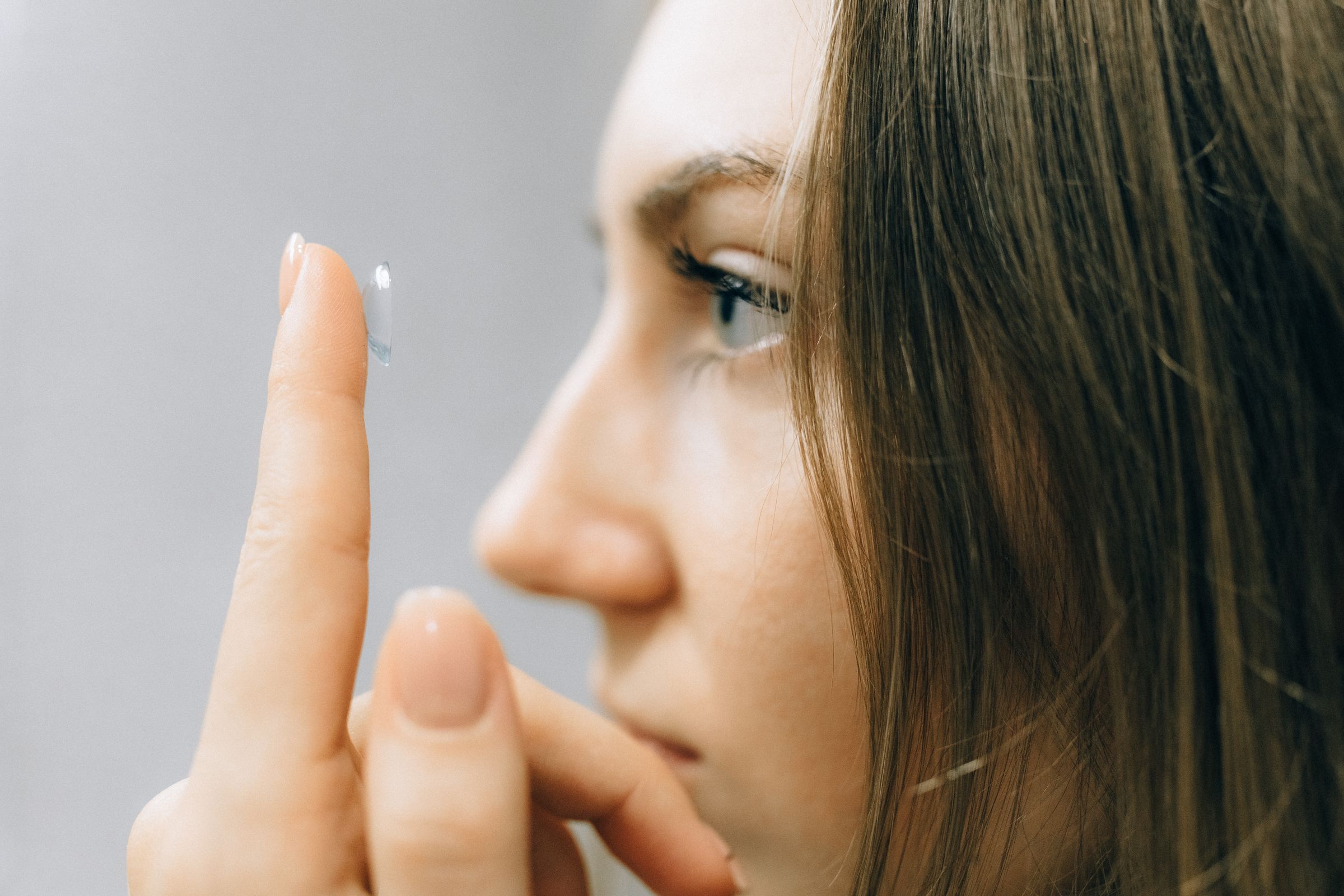 Young person handling a specialist contact lens